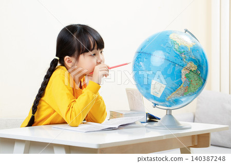 Asian little girl looking at globe, studying geography, focused child learning world map, education concept Asian little girl looking at globe, studying geography, focused child learning world map, education concept 140387248