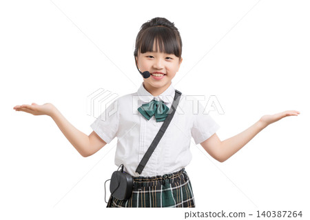 Asian schoolgirl presenting with headset microphone isolated on white background, child host and education concept Asian schoolgirl presenting with headset microphone isolated on white background, child host and education concept 140387264