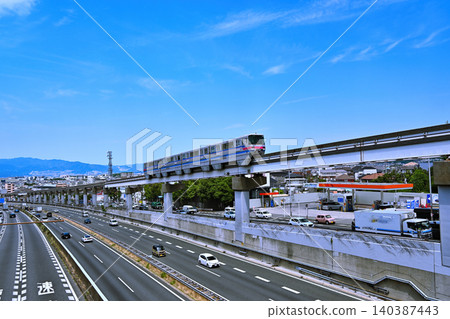 A monorail speeding along under a blue sky. A monorail speeding along under a blue sky. 140387443