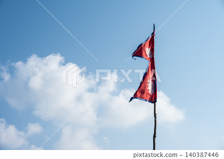 The national flag of Nepal against sky. The national flag of Nepal against sky. 140387446