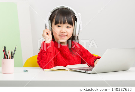 Asian little girl studying online with laptop and headset, interactive e-learning concept Asian little girl studying online with laptop and headset, interactive e-learning concept 140387653