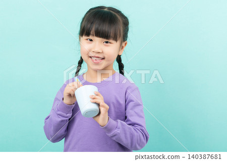 Healthy little girl brushing her teeth with a toothbrush and cup, dental hygiene and morning routine concept. Healthy little girl brushing her teeth with a toothbrush and cup, dental hygiene and morning routine concept. 140387681
