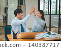 Business people are happy and give each other high fives. After success in doing business 140387717