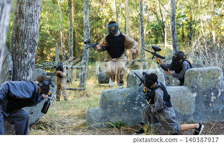 Attack of the paintball team on the enemy at army training ground Attack of the paintball team on the enemy at army training ground 140387917