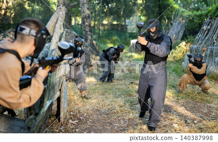 Tactical paintball team fighting on outdoor location 140387998