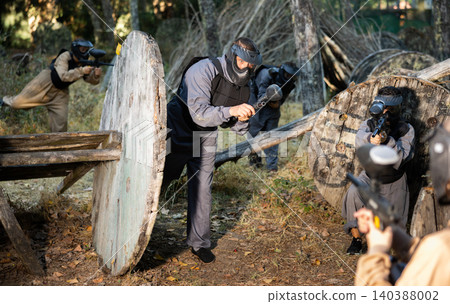 Teams facing on battlefield in outdoor paintball arena during match 140388002