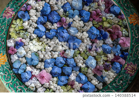 A beautiful scene of a flower arrangement in a water basin, with brightly colored hydrangeas adorning the basin. A beautiful scene of a flower arrangement in a water basin, with brightly colored hydrangeas adorning the basin. 140388514