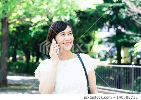 A woman who speaks with a smartphone A woman who speaks with a smartphone 140388713