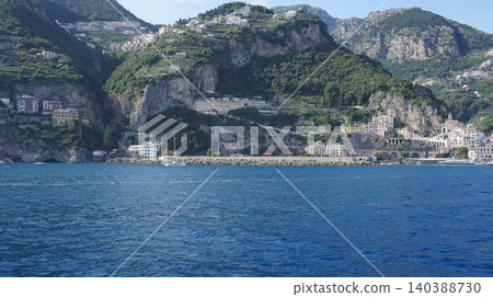 Facades of famous town of Amalfi, located on the Amalfi Coast, with its azure sea and beautiful colorful cliffside houses. 140388730