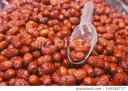 Dried Red Dates (Jujubes) in a Pile with a Scoop Dried Red Dates (Jujubes) in a Pile with a Scoop 140388737