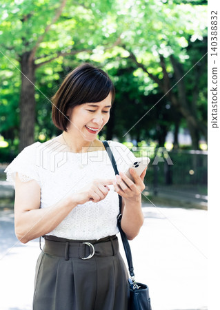 Woman operating a smartphone Woman operating a smartphone 140388832