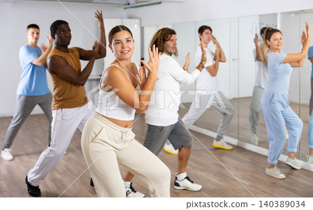 Group of different people rehearsing dance in dance studio Group of different people rehearsing dance in dance studio 140389034