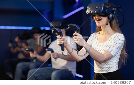 teenager in virtual reality glasses with joystick play survival game in tone jungle of future teenager in virtual reality glasses with joystick play survival game in tone jungle of future 140389207