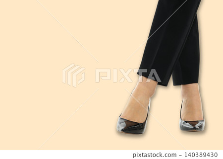 A woman shows fashionable shoes while posing with confidence 140389430
