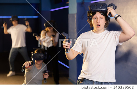 Portrait of young man with a very surprised look, who took off her virtual reality glasses Portrait of young man with a very surprised look, who took off her virtual reality glasses 140389508