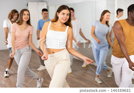 Group of different people rehearsing dance in dance studio Group of different people rehearsing dance in dance studio 140389681