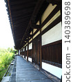 A national treasure corridor stretches into the height of silence. A refined wooden structure and fresh greenery stand behind the Zen room of the World Heritage site, Gangoji Temple. 140389698