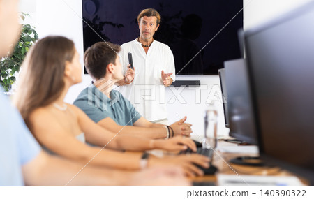 Male teacher enthusiastically explains Male teacher enthusiastically explains 140390322