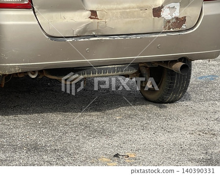 Rusted And Dented Rear Bumper Of Gold Car Rusted And Dented Rear Bumper Of Gold Car 140390331