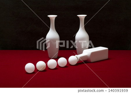 Still life with white vases on a table with a red coverlet 140391939