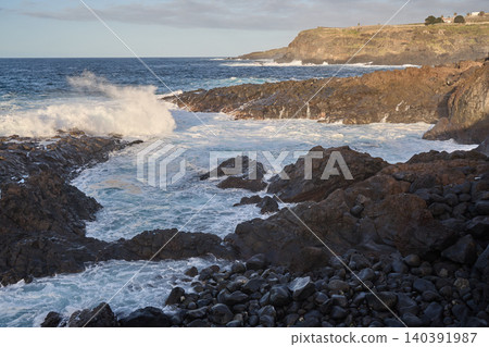 Ocean Waves Crashing on Rocky Volcanic Coastline 140391987