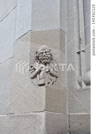 Stone relief of a scissor sharpener from 1900 on the Stadthaus facade in Zurich Switzerland Stone relief of a scissor sharpener from 1900 on the Stadthaus facade in Zurich Switzerland 140392128