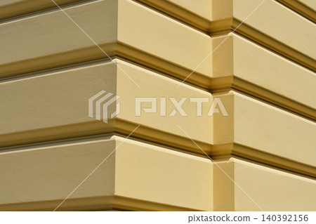 Yellow rusticated wall corner of classical building facade Yellow rusticated wall corner of classical building facade 140392156