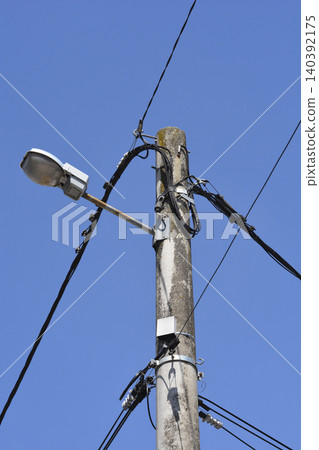 Concrete Utility Pole with Street Light and Cables Concrete Utility Pole with Street Light and Cables 140392175