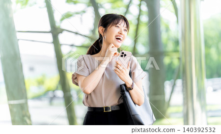 Woman/businesswoman using smartphone outdoors Woman/businesswoman using smartphone outdoors 140392532
