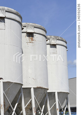 Industrial White Cement Silos Against Blue Sky Industrial White Cement Silos Against Blue Sky 140392636