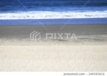 The sandy beach at the water's edge and the gentle waves. The sandy beach at the water's edge and the gentle waves. 140393818