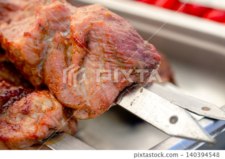 Grilled meat skewers delicious barbecue food outdoor cooking summer party meal savory pork kebab close-up. 140394548
