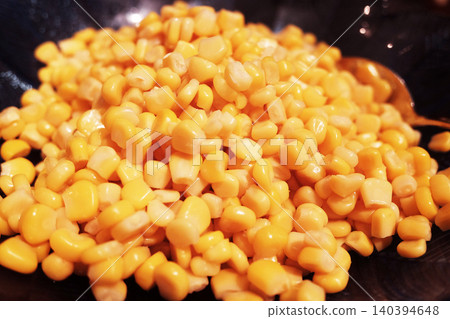 Close up of boiled corn seeds spinning in black dish 140394648