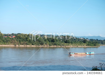 Beautiful Traditional boat  in Mekong river forms the border between Thailand and Laos with blue sky. 140394661