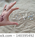 Shell writing on the sand 140395492