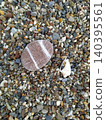 A stone and a shell on a pebble 140395561