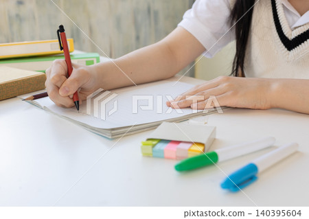 The hands of a girl who is studying The hands of a girl who is studying 140395604