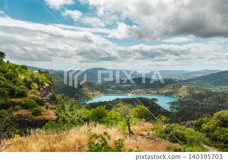 Mountain landscape with turquoise reservoir and rolling hills viewed from scenic overlook in Catalonia, Spain Mountain landscape with turquoise reservoir and rolling hills viewed from scenic overlook in Catalonia, Spain 140395703