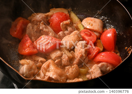 Chicken and Tomato: A scene of chicken and tomatoes being stir-fried. Chicken and Tomato: A scene of chicken and tomatoes being stir-fried. 140396776