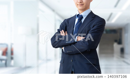 A businessman with his arms crossed. A businessman with his arms crossed. 140397106