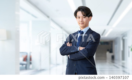 A businessman with his arms crossed. A businessman with his arms crossed. 140397107