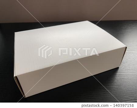 White Cardboard Box on Dark Wood Table 140397158