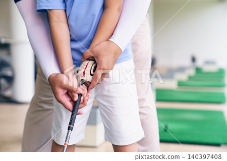Close up of golf instructor teaching student how to grip club Close up of golf instructor teaching student how to grip club 140397408