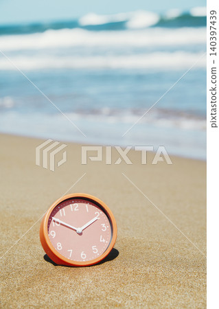 a clock rests in the sand at an empty beach a clock rests in the sand at an empty beach 140397439