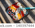 a close-up of sushi on a wooden bench 140397444