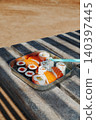 sushi and nigiri fill a metal lunch box on a table 140397445