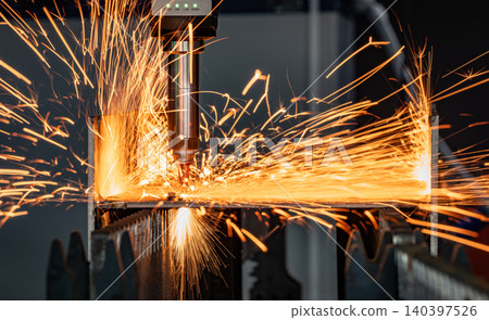 Industrial CNC laser cutting machine with flying sparks in metal fabrication. 140397526