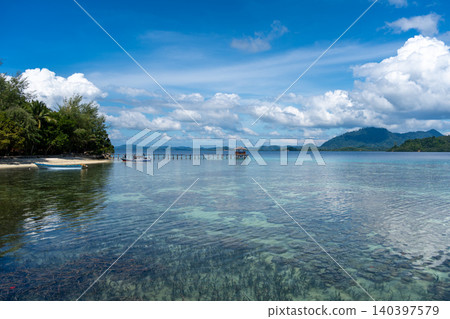 Wooden jetty and boat at Bolilanga Island, Togian archipelago, Sulawesi, Indonesia Wooden jetty and boat at Bolilanga Island, Togian archipelago, Sulawesi, Indonesia 140397579