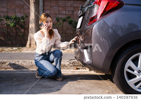 Woman calls insurance after two cars collide on road Woman calls insurance after two cars collide on road 140397936