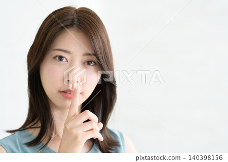 Japanese woman covers her mouth with her hand Japanese woman covers her mouth with her hand 140398156